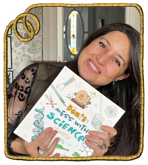 an author holding her book Don't mess with Science