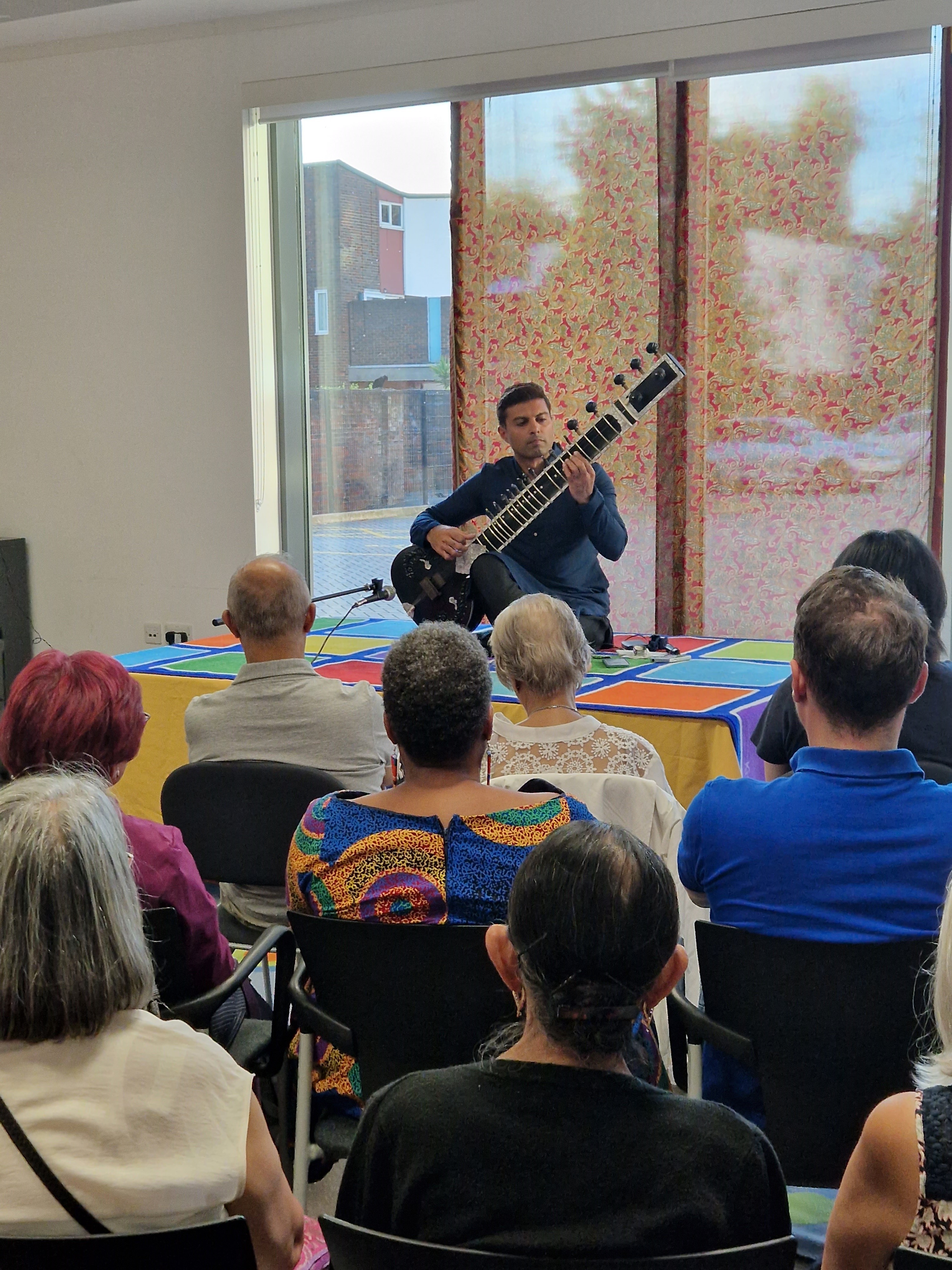 Audience watching Jay Pinara play the sitar