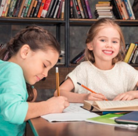 Two children engaged in writing activity