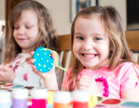 Two little girls having fun with craft