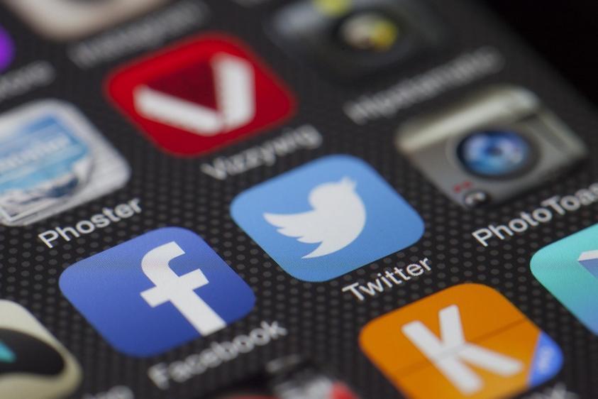 Social media icons on screen of phone
